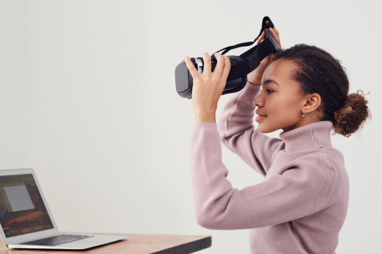 woman holding black vr headset